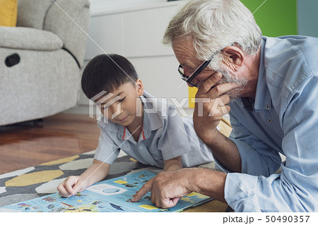 senior man happiness and grandson are sitting on 50490357
