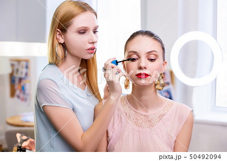 Nice young woman having her eyelashes painted Nice young woman having her eyelashes painted 50492094