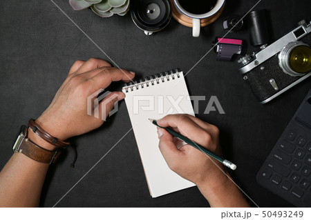 Creative photographer writing note with notebook Creative photographer writing note with notebook 50493249