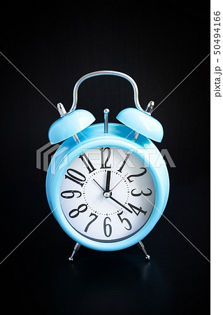 Blue alarm clock on black background 50494166