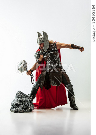 Man in cosplaying Thor isolated on white studio background Man in cosplaying Thor isolated on white studio background 50495564