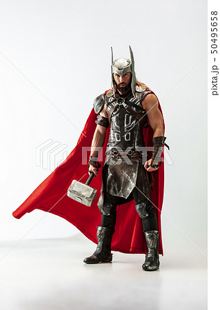 Man in cosplaying Thor isolated on white studio background Man in cosplaying Thor isolated on white studio background 50495658