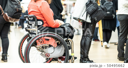 Close up of unrecognizable hanicapped woman on a wheelchair queuing in line to perform everyday 50495662