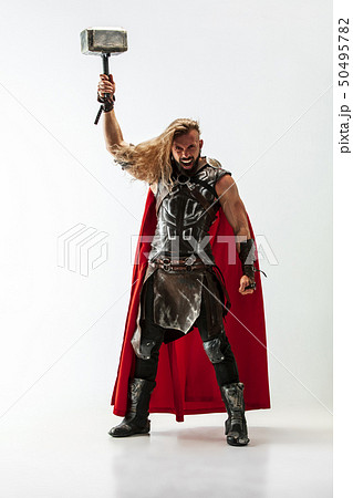 Man in cosplaying Thor isolated on white studio background 50495782