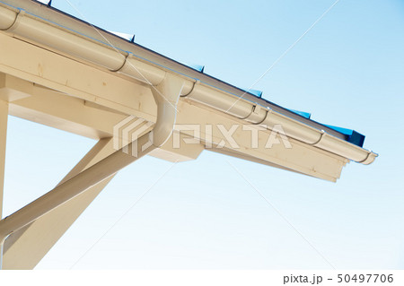Gutter on house corner. Metal eave on roof 50497706