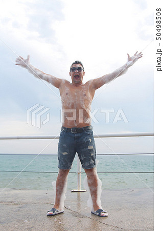 the man in glasses has fun in the white foam 50498508