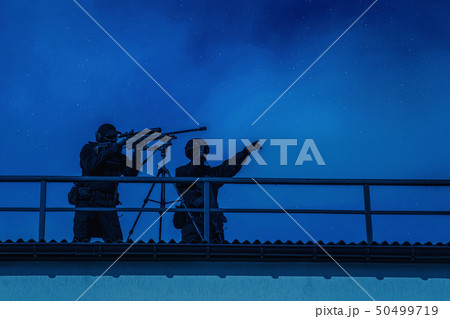 Sniper team searching target on city night mission 50499719