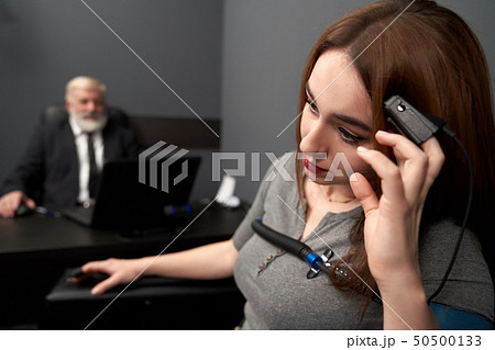 Woman leaning head on hand with finger sensor. 50500133