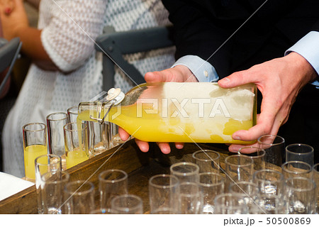 serving limoncello in glasses serving limoncello in glasses 50500869