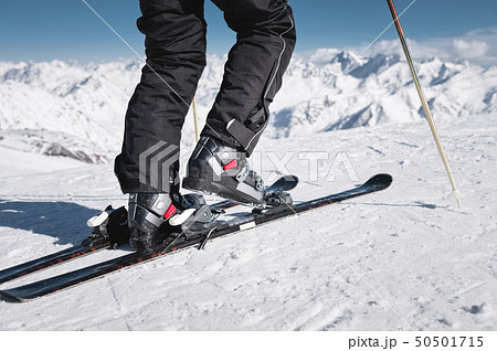 Close-up of the athlete's skier's foot in ski boots rises into the skis against the background of Close-up of the athlete's skier's foot in ski boots rises into the skis against the background of 50501715