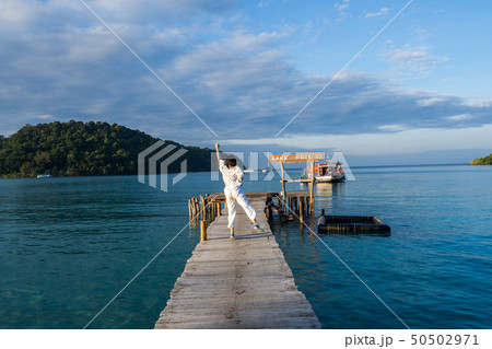 woman is relaxing on wood bridge in beautiful 50502971