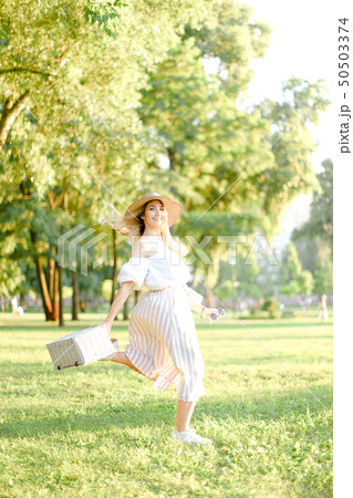 Young caucasian girl jumping in park and running, wearing fashionable clothes and hat. Young caucasian girl jumping in park and running, wearing fashionable clothes and hat. 50503374