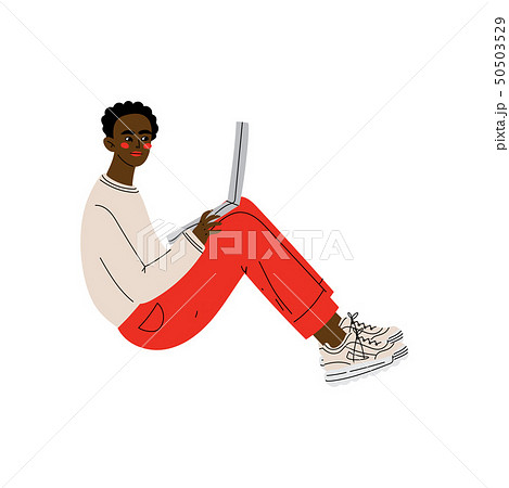 Guy Sitting on Floor with Laptop, Young African American Man Working or Relaxing Using Computer 50503529