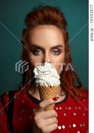 Pretty model holding delicious white ice cream. Pretty model holding delicious white ice cream. 50503677