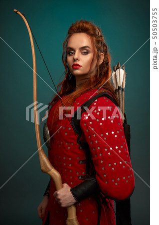 Gorgeous woman in medieval tunic with bow and arrows. 50503755