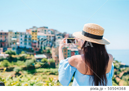 Tourist looking at scenic view of Vernazza, Cinque Terre, Liguria, Italy Tourist looking at scenic view of Vernazza, Cinque Terre, Liguria, Italy 50504368