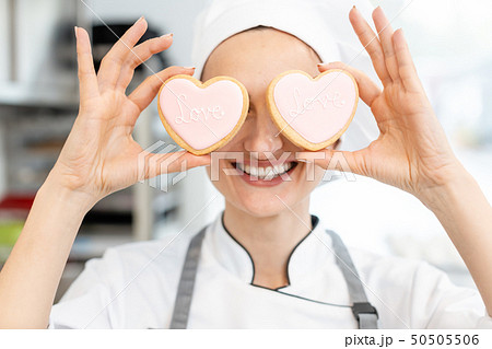 Confectioner with heart shaped cookies Confectioner with heart shaped cookies 50505506