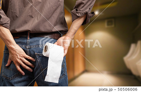 man holding toilet tissue roll in toilet man holding toilet tissue roll in toilet 50506006