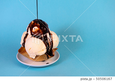 scoops of vanilla ice cream in waffle cone bowl scoops of vanilla ice cream in waffle cone bowl 50506167