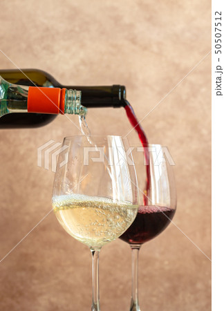 White and red wine pouring into glasses 50507512
