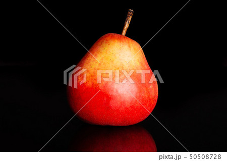 Fresh red pear isolated on black glass Fresh red pear isolated on black glass 50508728