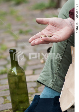 closeup of euros coins in hand of poor woman 50509977