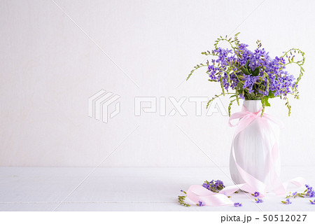 lovely purple flower in vase on white wooden 50512027