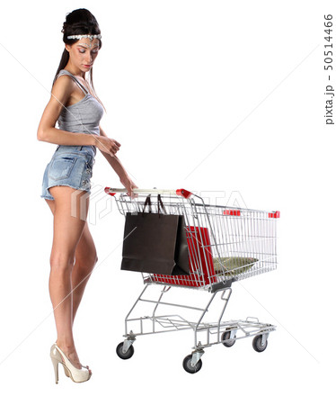 Pretty brunette woman and shopping trolley with a shopping bags Pretty brunette woman and shopping trolley with a shopping bags 50514466