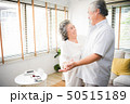 Lover senior couple dance together at home.  50515189