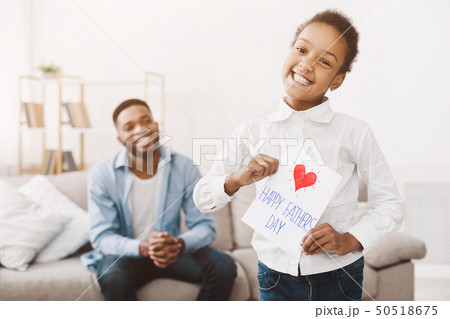 African-american girl holding handmade postcard, congratulating dad African-american girl holding handmade postcard, congratulating dad 50518675