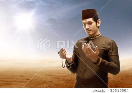 Asian muslim man standing and praying 50519594