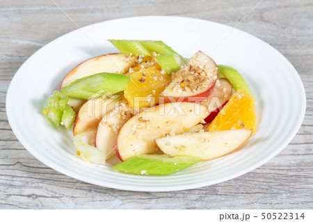 Dietary food. Plate of salad with fruits, celery 50522314