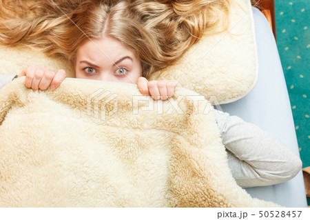 Woman waking up under wool woolen blanket. 50528457