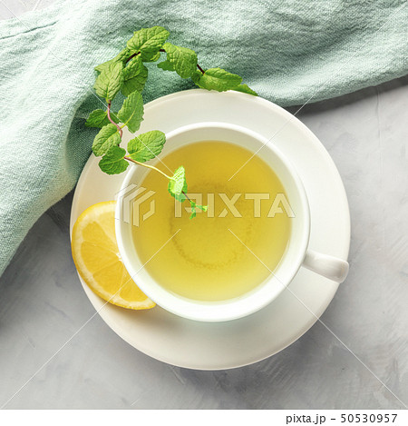 A cup of green tea with lemon and mint leaves, shot from the top A cup of green tea with lemon and mint leaves, shot from the top 50530957