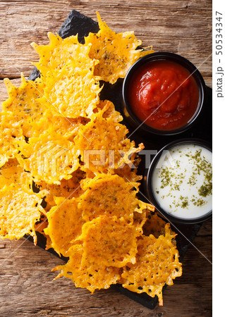 Fried cheddar cheese chips with herbs served with Fried cheddar cheese chips with herbs served with 50534347
