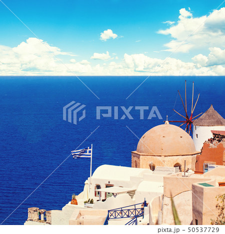 Santorini landscape with greek flag, white houses Santorini landscape with greek flag, white houses 50537729
