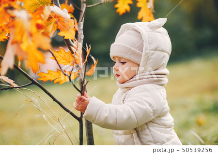 Little girl in a autumn park 50539256