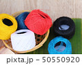 Colorful thread for sewing on wood background 50550920