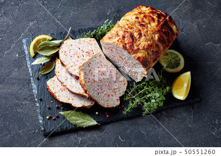 sliced chicken terrine on a black slate 50551260