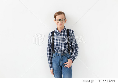 teenager, children and fashion concept - kid dressed in plaid shirt posing over white background teenager, children and fashion concept - kid dressed in plaid shirt posing over white background 50551644