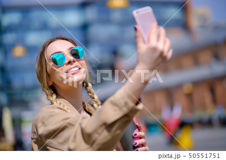 Young woman selfie in the street with a 50551751