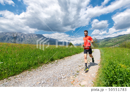 Ultra trail runner athlete prepares on a dirt road Ultra trail runner athlete prepares on a dirt road 50551783