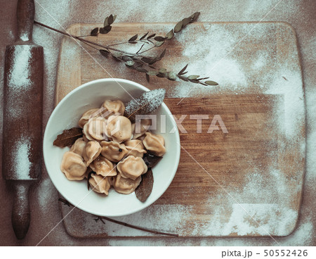 ready dumplings in a plate on a wooden board with ready dumplings in a plate on a wooden board with 50552426