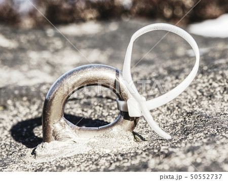 Detail of steel bolt anchor eye in rock. Detail of steel bolt anchor eye in rock. 50552737