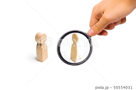 Magnifying glass is looking at the a fake person. 50554031
