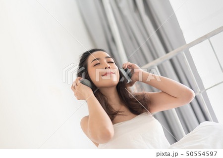 Pretty girl listening music with a headphones in Pretty girl listening music with a headphones in 50554597