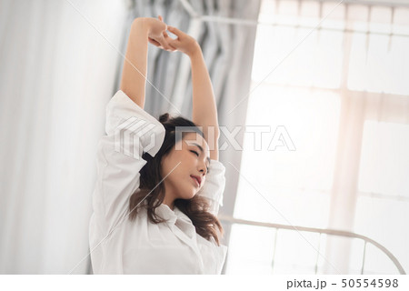 Pretty Asian woman stretching her arms. Pretty Asian woman stretching her arms. 50554598