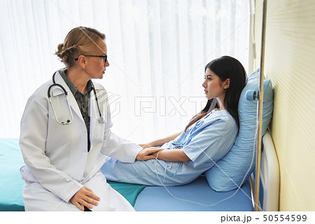 Senior Doctor reassuring Female patient. Senior Doctor reassuring Female patient. 50554599
