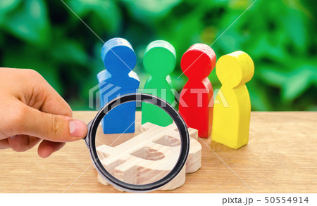 multi-colored figures of people surround a bitcoin 50554914