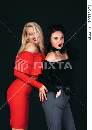 young women friends standing over black background 50555071